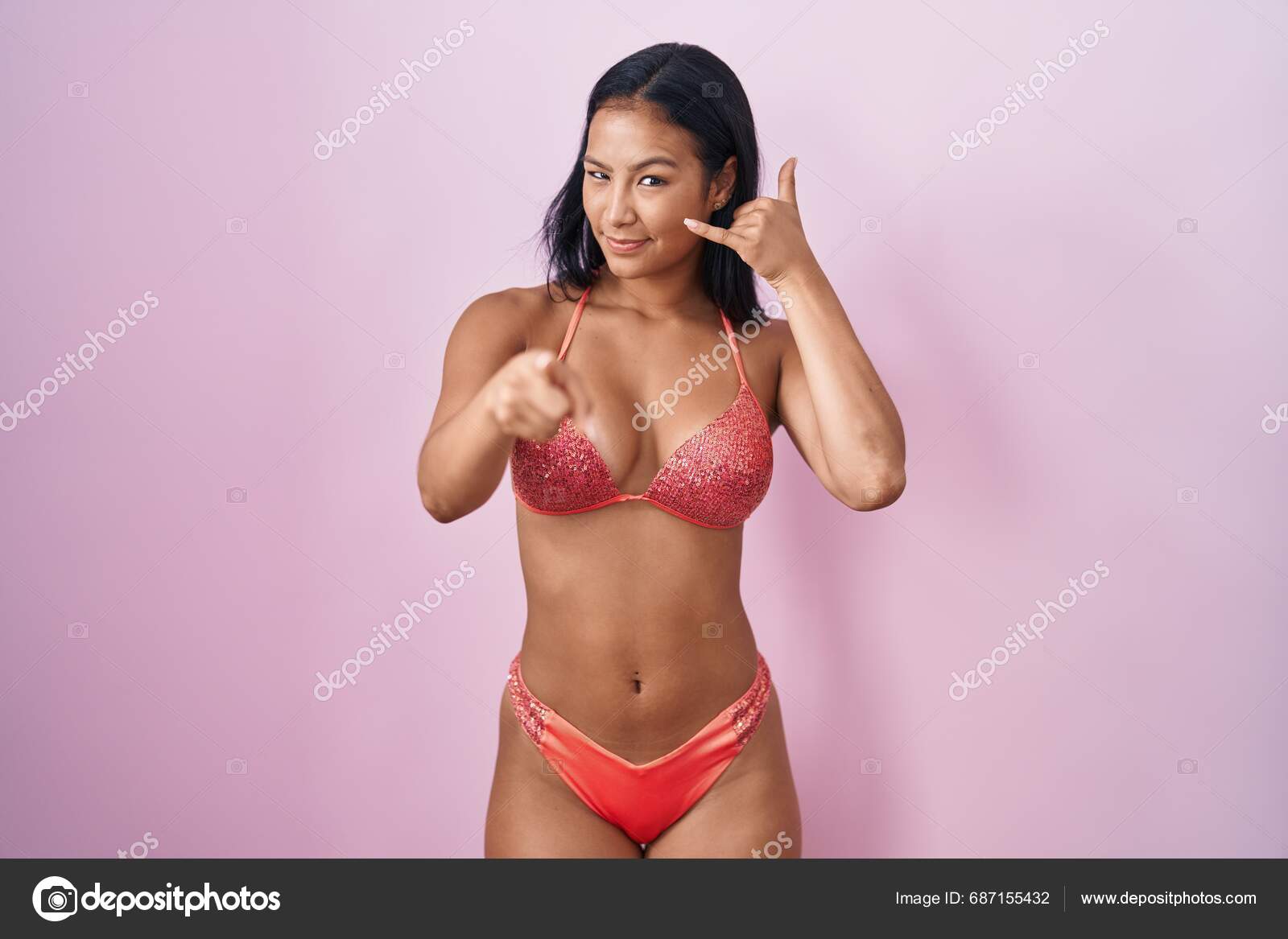 Hispanic Woman Wearing Bikini Smiling Doing Talking Telephone Gesture