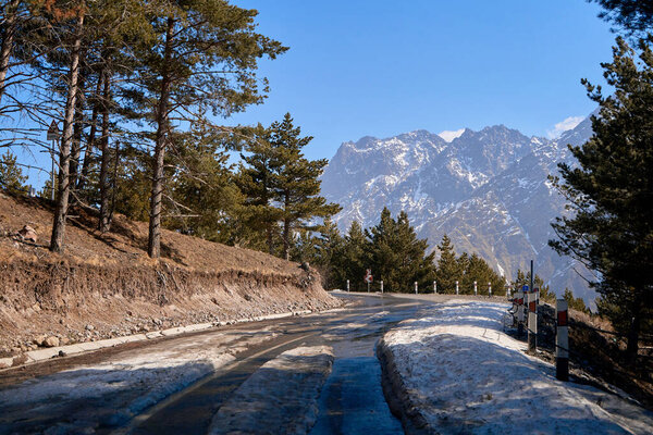 Dangerous winding road among the mountains. Mountain streamer in early spring. Spectacular mountain landscape.