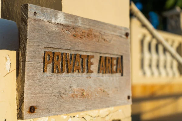 A sign warning about entering a private area, hanging on the fence of the property.