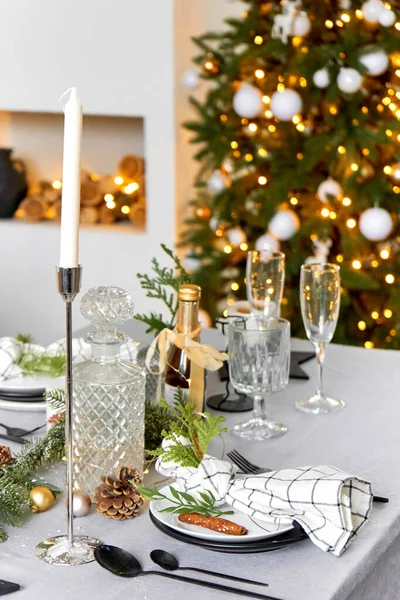 Light festive Christmas interior, set table for a festive dinner.