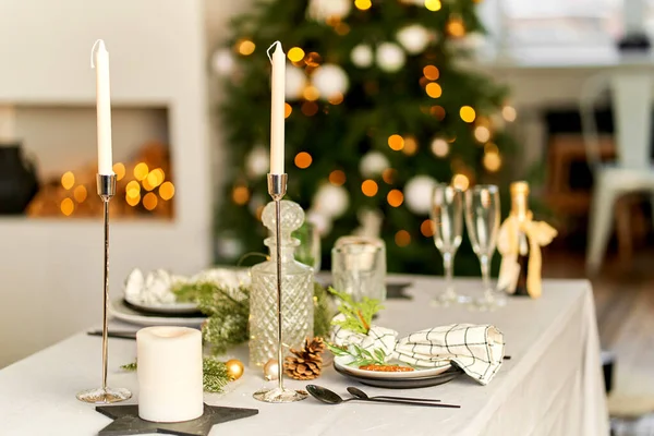 Light festive Christmas interior, set table for a festive dinner.