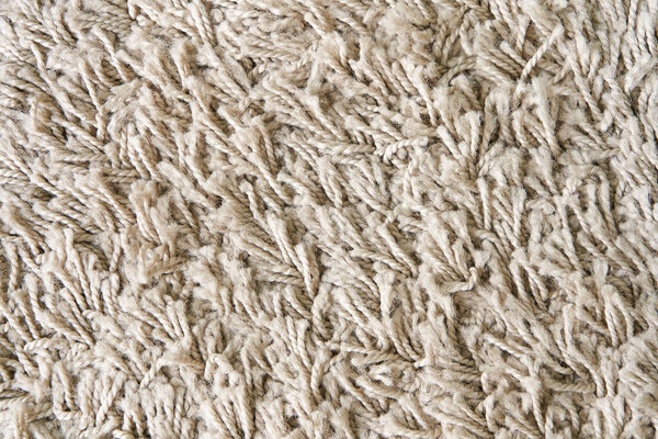 Текстура мягкого, шершавого, светлого ковра на полу.