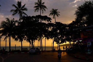 Sunset at the seashore. Listening to people walking among the palm trees.Thailand, Krabi - 10.12.2022