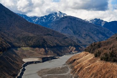 A mountainous landscape with a large dewatered mountain river.