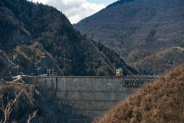 The dam of the Inguri hydroelectric power plant in the Sakartvelo mountains. A natural mountain landscape with energetic infrastructure.