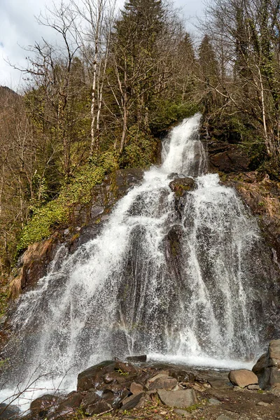 Mountain Falls. The water breaks over the mountain rocks in several tiers.