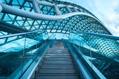 Tourist landmark Peace Bridge over the Mtkvari River in the city of Tbilisi. Tbilisi, Georgia - 03.20.2021