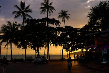 Sunset at the seashore. Listening to people walking among the palm trees.Thailand, Krabi - 10.12.2022
