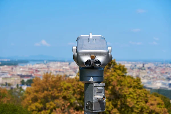 Observation binoculars in a city park looking out over the city.