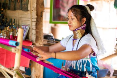 Long-Necked Tribe Woman Portrait: Celebrating cultural diversity and tradition through striking features and intricate jewelry. Perfect for design projects and editorial content related to culture and identity. Chiang Rai, Thailand - 02.09.2023 clipart