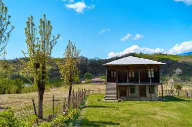 Detached old two-story wooden house. Traditional Georgian house in the village.
