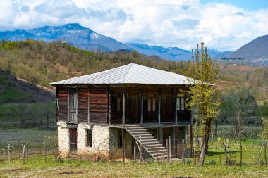 Detached old two-story wooden house. Traditional Georgian house in the village.