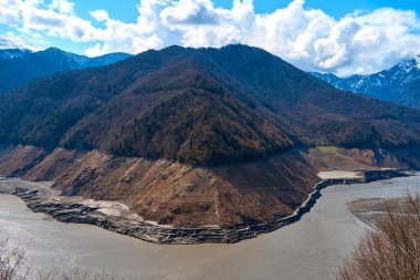 A mountainous landscape with a large dewatered mountain river.