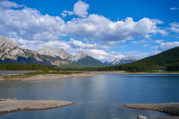 stock image An incredible view of a natural mountain lake on a sunny summer day against the backdrop of the rocky mountains of Alberta in Canada