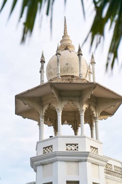 Büyük Asya şehri Kuala Lumpur 'un merkezinde eski bir tren istasyonu kulesi olan beyaz bir bina. Kuala Lumpur, Malezya - 11.15.2022