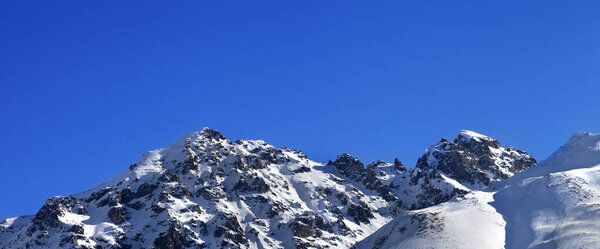 Panoramic view on snowy rocks and off-piste slope in sunny morning. Caucasus Mountains in winter, Tetnuldi, Svaneti region of Georgia.