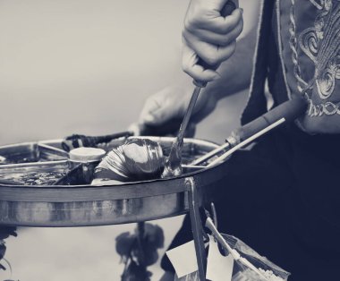 Macun - soft, sweet Turkish toffee paste in traditional container. Street food in Istanbul, Turkey. Black and white retro toned image.