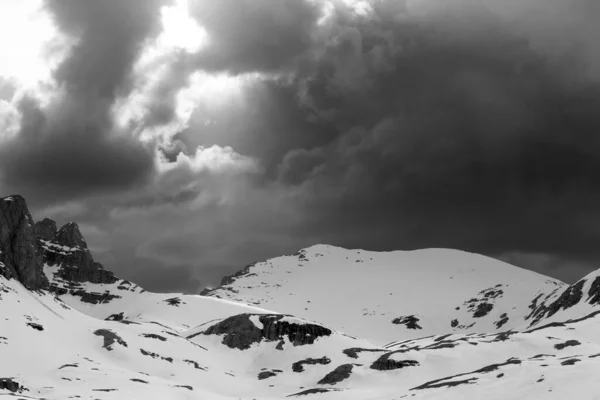 Snowy mountains and storm clouds at high winter mountains. Turkey, Central Taurus Mountains, Aladaglar (Anti Taurus) view from plateau Edigel (Yedi Goller). Black and white toned landscape