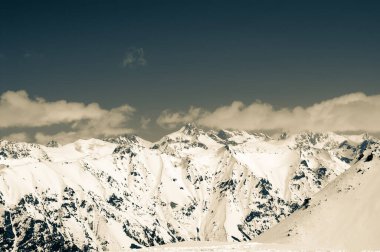 High winter snowy mountains. Caucasus Mountains, region Dombay. Retro color toned landscape.