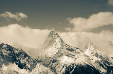 High winter snowy mountains. Caucasus Mountains, region Dombay, Mount Belalakaya. Retro color toned landscape.