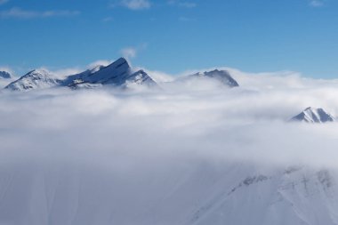 Güneşli bir günde sisli, karlı güneş ışığı dağları. Kışın Kafkasya Dağları, Gürcistan, Gudauri bölgesi.