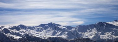 Sunlight snowy mountains in nice winter evening. Caucasus Mountains. Georgia, region Svanetia. Panoramic view.