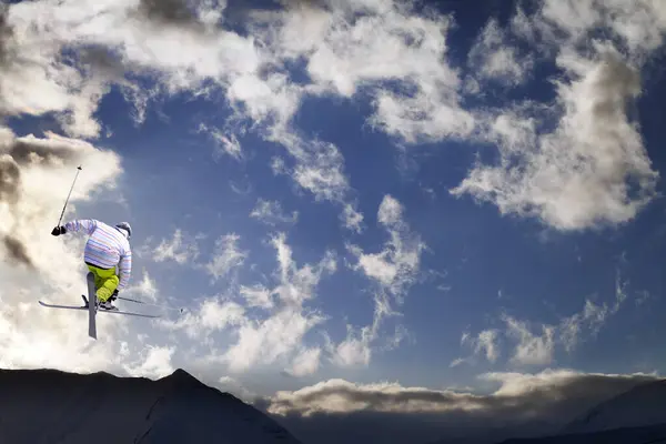Freestyle Ski Jumper Crossed Skis Snowy Mountains Blue Sky Sunlit — Photo