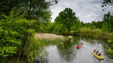 Kayaking on the river. Several kayaks with teams on board compete with each othe