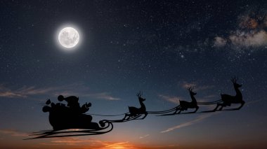 Noel Baba, Noel arifesinde gökyüzünde karla uçar.