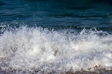 white waves in the blue sea