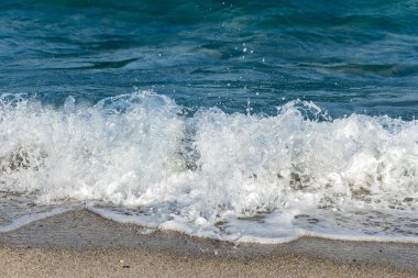 white waves in the blue sea