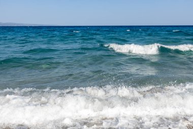Sahildeki mavi denizde beyaz dalgalar