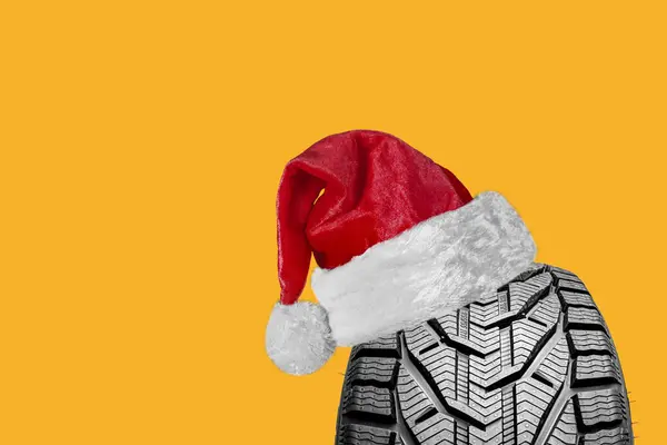 a black isolation rubber tire, with a Santa Claus hat for Christmas