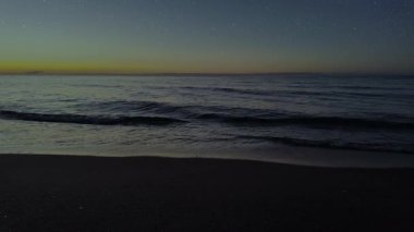 Gece gökyüzünde dağların manzaralı bir yıldız hareketi..