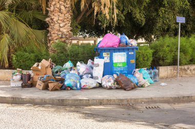 Limassol, Cyprus - October 24, 2020 - Plastic and paper garbage in the city street, waiting waste trucks.