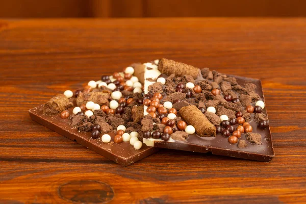 Homemade organic chocolate on brown wooden background. Brown backdrop.