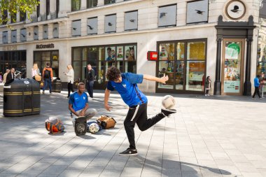 Londra, Birleşik Krallık - 24 Eylül 2021 Leicester Meydanı 'ndaki İsviçre Glockenspiel' de sokak futbolcusu gösterisi.