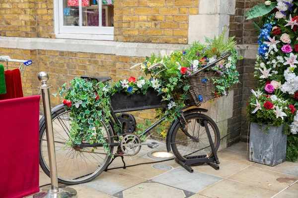 ロンドンの壁にバスケットの花と自転車 — ストック写真