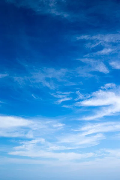 blue sky background with tiny clouds