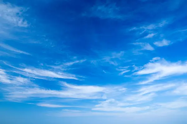 blue sky background with tiny clouds