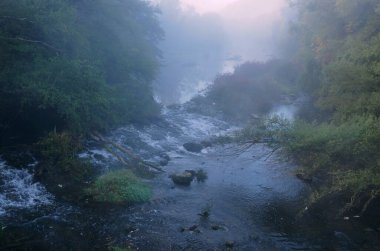 Foggy view of the Yantra river in Bulgaria early in the morning in October         clipart