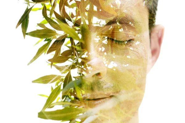 A full frontal closeup portrait of a man with eyes closed in double exposure technique