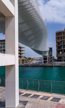 Dubai Su Kanalı köprüsünün sarmal dizaynı su yolu üzerinde apartman blokları üzerine