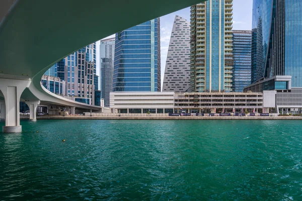 ドバイ アラブ首長国連邦 2023年4月2日 ウォーターフロントのアパートブロックと橋でドバイ運河沿いのサイクルパス — ストック写真