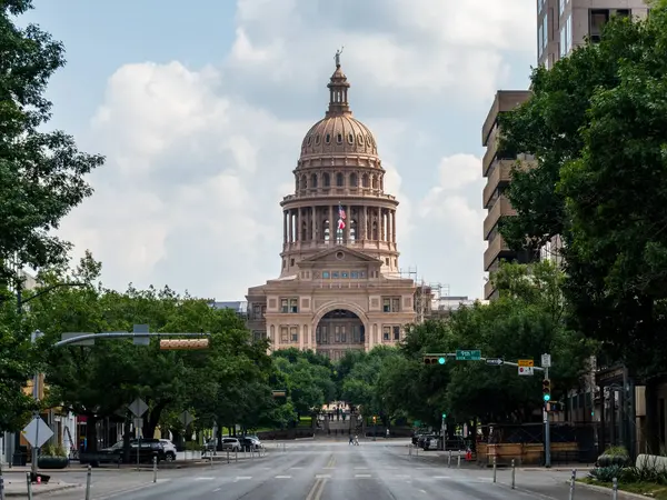 Stock image View along Congress Avenue to the entrance and dome of the Texas State Capitol with empty street