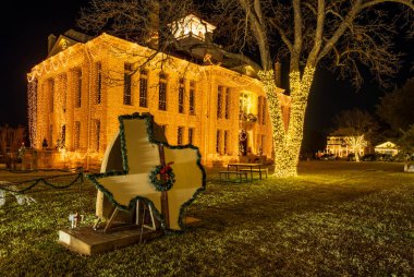 Twinkling lights hanging from the Blanco County courthouse each December in Johnson City, Texas clipart