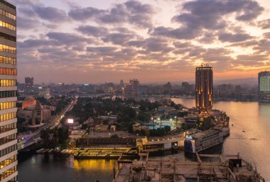 Cairo, Egypt - 29 October 2024: Aerial view across Sharia el Orman island to Sofitel hotel and downtown Cairo at sunset clipart