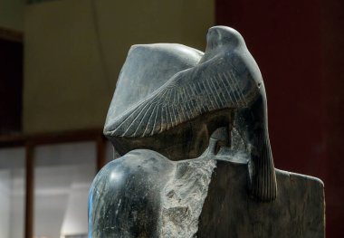 Kahire 'deki Mısır müzesindeki tarihi Khafre heykelinin arkasında Horus' u şahin kanatlarıyla gösteren bir detay var.