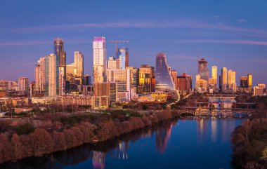 City skyline from the west of downtown Austin Texas from Zilker metropolitan park after sunset as the buildings are illuminated in the city clipart