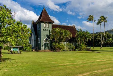 Hanalei, Kauai - 30 January 2025: Waioli Huiia Church stands in Hanalei, Kauai, with the majestic mountains in the background clipart